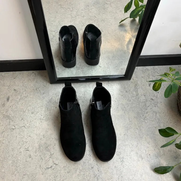 Kort sort støvle med lakdetaljer ved hælen