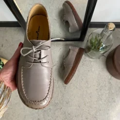 Sandfarvet snøresko i læder med god stødabsorbering.